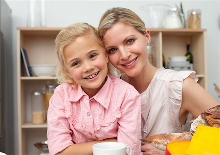 simsearch:400-04206231,k - Jolly little girl eating fruit with her mother in the kitchen Stock Photo - Budget Royalty-Free & Subscription, Code: 400-04195685