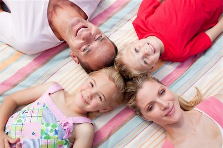 Jolly family lying on the grass in a park Stock Photo - Budget Royalty-Free & Subscription, Code: 400-04195714