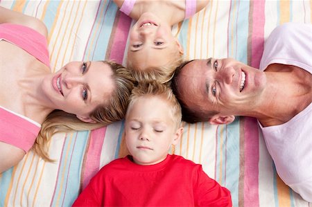 Cheerful family sleeping lying on the grass in a park Stock Photo - Budget Royalty-Free & Subscription, Code: 400-04195723