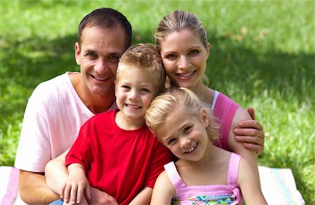 Close-up of a happy family smiling at the camera in a park Stock Photo - Budget Royalty-Free & Subscription, Code: 400-04195745