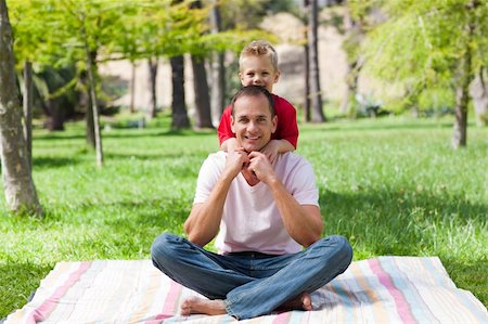 Father and his son having fun at a picnic in a park Stock Photo - Budget Royalty-Free & Subscription, Code: 400-04195746