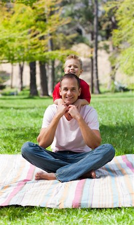 Cute little boy hugging his father in a park Stock Photo - Budget Royalty-Free & Subscription, Code: 400-04195747