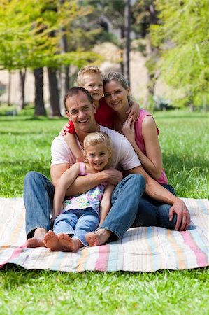 Portrait of young family having a picnic in a park Stock Photo - Budget Royalty-Free & Subscription, Code: 400-04195748