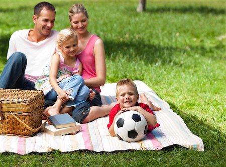 father and girl playing soccer - Happy parents and children picnicing in the park and smiling at the camera Stock Photo - Budget Royalty-Free & Subscription, Code: 400-04195760