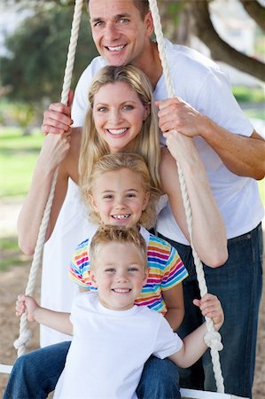 simsearch:400-04195786,k - Jolly family swinging in a park Foto de stock - Royalty-Free Super Valor e Assinatura, Número: 400-04195850