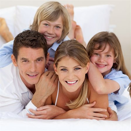 simsearch:400-04192370,k - Happy family having fun together lying on a bed Stock Photo - Budget Royalty-Free & Subscription, Code: 400-04195914