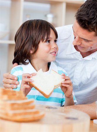 Adorable little boy and his father eating bread in the kitchen Stock Photo - Budget Royalty-Free & Subscription, Code: 400-04195974