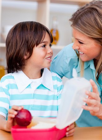 simsearch:400-04791807,k - Joyful little boy and his mother preparing his snack in the kitchen Photographie de stock - Aubaine LD & Abonnement, Code: 400-04195975