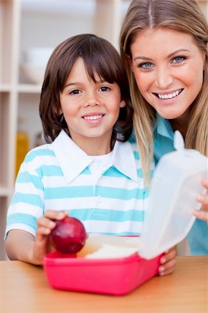 simsearch:400-04206231,k - Cheerful little boy and his mother preparing his snack in the kitchen Stock Photo - Budget Royalty-Free & Subscription, Code: 400-04195984