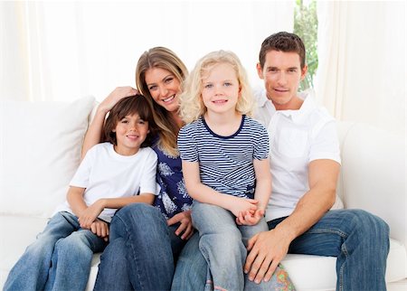 simsearch:400-04540885,k - Joyful family watching television sitting on sofa at home Foto de stock - Royalty-Free Super Valor e Assinatura, Número: 400-04196009
