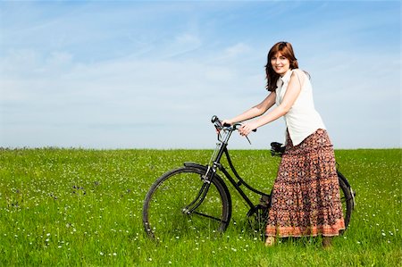 simsearch:400-04201795,k - Happy young woman with a vintage bicycle on a green meadow Stock Photo - Budget Royalty-Free & Subscription, Code: 400-04196128