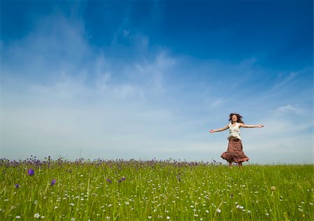 Young woman dancing on a beautiful green meadow Stock Photo - Budget Royalty-Free & Subscription, Code: 400-04196136