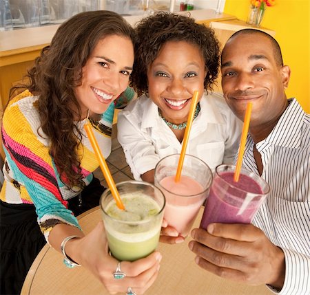 drinking milk shake - A group of friends are holding smoothies and smiling at the camera.  Square shot. Stock Photo - Budget Royalty-Free & Subscription, Code: 400-04196275