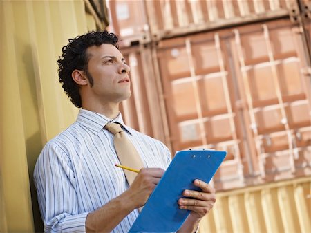 people warehouse freight - portrait of mid adult businessman leaning on cargo container and looking up. Horizontal shape, side view, copy space Photographie de stock - Aubaine LD & Abonnement, Code: 400-04196868