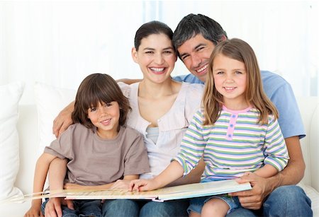 simsearch:400-04193532,k - Joyful family reading together on the sofa at home Stock Photo - Budget Royalty-Free & Subscription, Code: 400-04196969