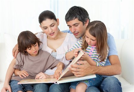 simsearch:400-04193532,k - Attentive parents reading with their children on the sofa Stock Photo - Budget Royalty-Free & Subscription, Code: 400-04196970