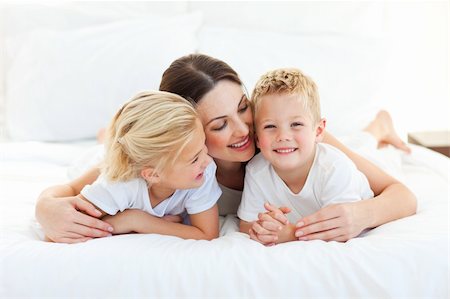 simsearch:400-05749479,k - Cute children and their mom having fun lying on a bed at home Foto de stock - Royalty-Free Super Valor e Assinatura, Número: 400-04197272