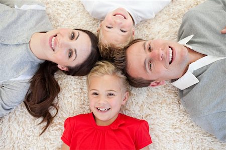 Happy family lying on the floor in circle Stock Photo - Budget Royalty-Free & Subscription, Code: 400-04197432