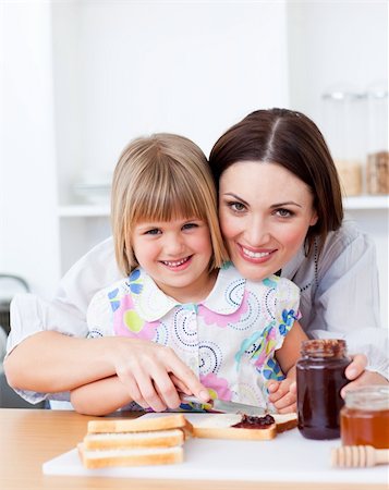 simsearch:400-04206231,k - Cute little girl and her mother preparing toasts in the kitchen Stock Photo - Budget Royalty-Free & Subscription, Code: 400-04197456