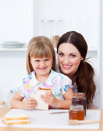 simsearch:400-04206231,k - Cute little girl and her mother eating slices of bread in the kitchen Stock Photo - Budget Royalty-Free & Subscription, Code: 400-04197459