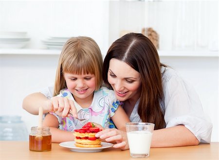 simsearch:400-04206231,k - Merry little girl and her mother having breakfast in the kitchen Stock Photo - Budget Royalty-Free & Subscription, Code: 400-04197452