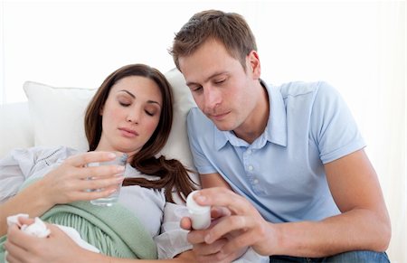 sneezing into hands - Young man looking after his wife with the flu at home Photographie de stock - Aubaine LD & Abonnement, Code: 400-04197577