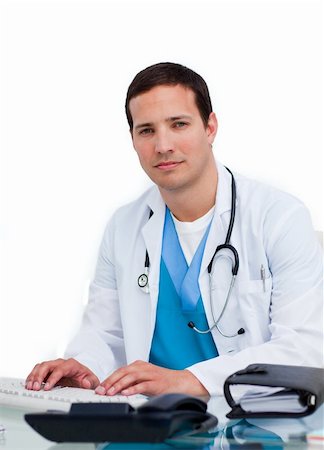 simsearch:400-04191693,k - Charming male doctor working at a computer against a white background Stock Photo - Budget Royalty-Free & Subscription, Code: 400-04197659