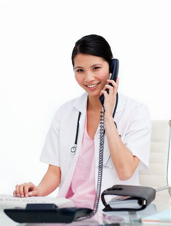 simsearch:400-04704005,k - Asian doctor talking on phone against a white background Stock Photo - Budget Royalty-Free & Subscription, Code: 400-04197707