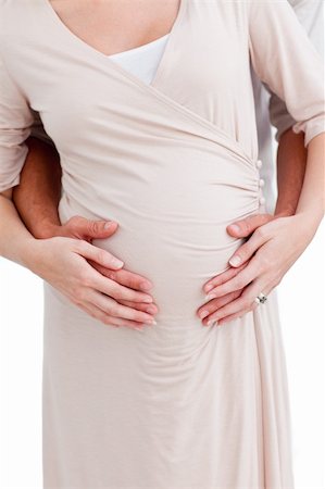 simsearch:400-07322828,k - Close-up of a pregnant woman with her husband against a white background Fotografie stock - Microstock e Abbonamento, Codice: 400-04197734