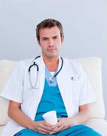 doctors coffee - Serious male doctor drinking coffee in the staff room Stock Photo - Budget Royalty-Free & Subscription, Code: 400-04197795