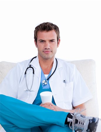 doctors coffee - Confident male doctor drinking coffee in the staff room against a white background Stock Photo - Budget Royalty-Free & Subscription, Code: 400-04197793