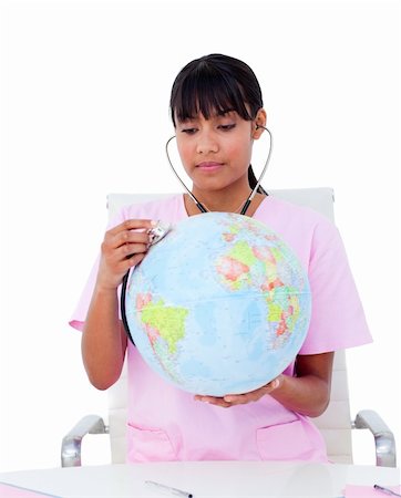 Portrait of an ethnic doctor examining a terrestrial globe against a white background Foto de stock - Super Valor sin royalties y Suscripción, Código: 400-04197801