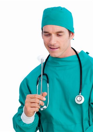 simsearch:400-04281577,k - Portrait of a serious surgeon holding surgical forceps against a white background Photographie de stock - Aubaine LD & Abonnement, Code: 400-04197845