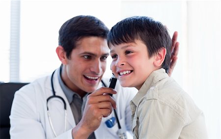 simsearch:400-05192324,k - Smiling doctor examining little boy's ears at the practice Stock Photo - Budget Royalty-Free & Subscription, Code: 400-04198306