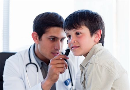 simsearch:400-05192324,k - Young doctor examining little boy's ears at the practice Stock Photo - Budget Royalty-Free & Subscription, Code: 400-04198308