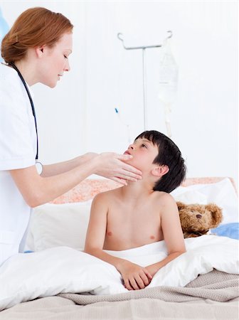 Female doctor examining a little boy at the hospital Stock Photo - Budget Royalty-Free & Subscription, Code: 400-04198320