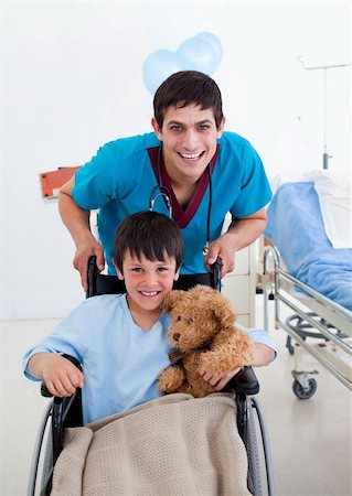simsearch:400-05147195,k - Portrait of a little boy sitting on wheelchair and a doctor at the hospital Stock Photo - Budget Royalty-Free & Subscription, Code: 400-04198334