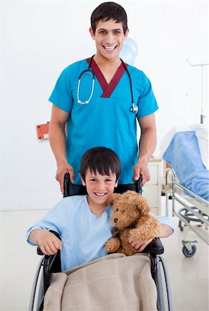 simsearch:400-05147195,k - Portrait of a cute little boy sitting on wheelchair and a doctor at the hospital Stock Photo - Budget Royalty-Free & Subscription, Code: 400-04198333