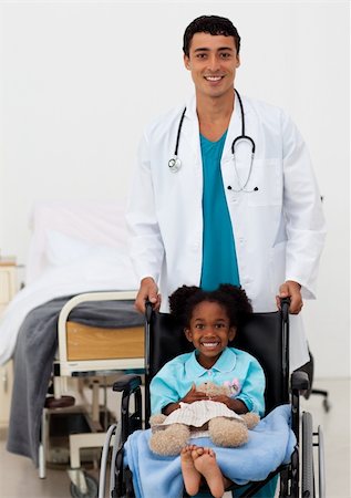 Young male doctor and Smiling girl on a wheelchair with thumb up in the hospital Stock Photo - Budget Royalty-Free & Subscription, Code: 400-04198405