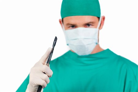 simsearch:400-04177437,k - Concentrated surgeon holding a scalpel isolated on a white background Photographie de stock - Aubaine LD & Abonnement, Code: 400-04198469