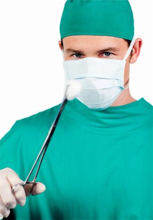 simsearch:700-01030251,k - Self-assured male surgeon holding surgical forceps against a white background Fotografie stock - Microstock e Abbonamento, Codice: 400-04198470