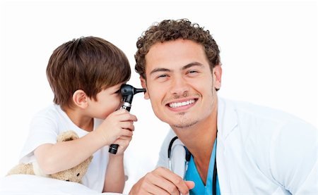 simsearch:400-05265698,k - Little boy checking doctor's ears against a white background Foto de stock - Super Valor sin royalties y Suscripción, Código: 400-04198494
