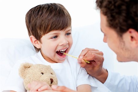sick boy with teddy - Positive doctor taking little boy's temperature at the hospital Stock Photo - Budget Royalty-Free & Subscription, Code: 400-04198502