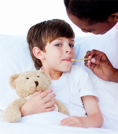 simsearch:400-06734741,k - Serious nurse taking child's temperature in a hospital Photographie de stock - Aubaine LD & Abonnement, Code: 400-04198518