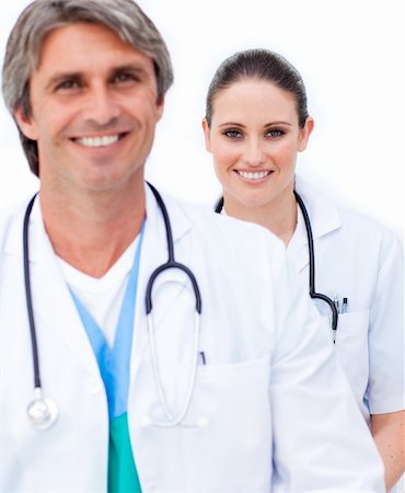 surgical team - Two smiling doctors looking at the camera against a white background Stock Photo - Budget Royalty-Free & Subscription, Code: 400-04198544