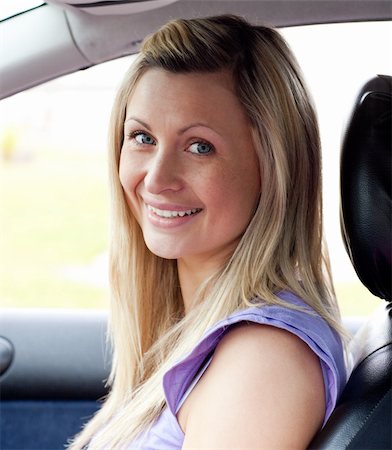 Portrait of a smiling young female driver sitting in her car Stock Photo - Budget Royalty-Free & Subscription, Code: 400-04198615