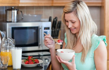 simsearch:400-04708507,k - Jolly woman having an healthy breakfast in a kitchen at home Stock Photo - Budget Royalty-Free & Subscription, Code: 400-04198631