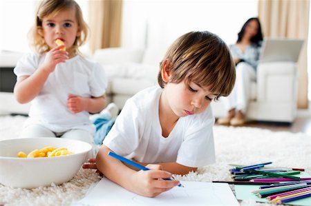 simsearch:6109-07601494,k - Cute little gir eating chips and her brother drawing in the living-room Stock Photo - Budget Royalty-Free & Subscription, Code: 400-04198766