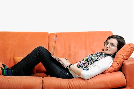 floor heat - young business woman in casual clothes working on laptop computer on orange sofa isolated on white Stock Photo - Budget Royalty-Free & Subscription, Code: 400-04198796
