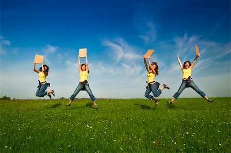 simsearch:400-04201795,k - Beautiful young woman jumping and holding a blank paper card Fotografie stock - Microstock e Abbonamento, Codice: 400-04198827